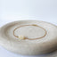 Gold bracelet with opals on a stone surface