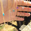 A product shot shows a hand touching a group of layered necklace sets. It shows different birthstone necklaces in turquoise, prehnite, Swiss blue topaz, amethyst, citrine, moonstone, aquamarine, and smoky quartz with a minimalist circle necklace for the longer necklace.