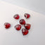 Red garnet gemstones on a white background