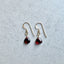 Garnet earrings on a light gray background