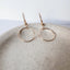 Closeup of dainty gold circle earrings