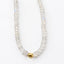 Close-up of faceted rainbow moonstone rondelles with blue flash and a 14k gold-filled center bead