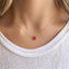 Dainty carnelian necklace worn at the collarbone