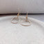 a product shot showing our dainty earrings featuring dainty circles that drop from a delicate, lightweight ear wire with a tiny gold ball.