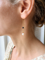 Black onyx and pearl threader earring worn with a floral top - Lolabean