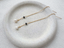 Gold filled black onyx and pearl threader earrings on a stone dish - Lolabean