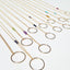 Gold necklaces with circular pendants on a white background