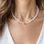 Model wearing a 16-inch rainbow moonstone beaded necklace with a single gold-filled bead at the center