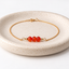 Carnelian beaded bracelet with three faceted carnelian beads