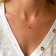 Carnelian beaded necklace worn at the collarbone