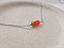 Carnelian beaded necklace in sterling silver on a stone dish