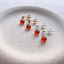 Carnelian stud earrings in 14k gold-filled and sterling silver on a stone dish