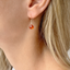 Dainty carnelian drop earring in 14k gold-filled worn on the ear