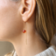 Dainty carnelian threader earring worn on the ear