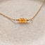 Close-up of three faceted citrine beads on a 14k gold-filled chain