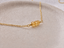 Three-bead citrine necklace in 14k gold-filled on a stone dish