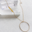 Long circle necklace with citrine in 14k gold filled on woven fabric