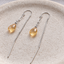 Citrine paperclip threader earrings in sterling silver on a ceramic dish