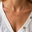 Three-bead citrine necklace worn with a white cardigan