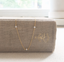 Cubic zirconia station necklace hanging over a linen-bound book