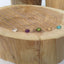 Gold necklaces with colorful beads on a wooden surface