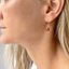 Side profile of a model wearing a carnelian heart drop earring in 14k gold-filled