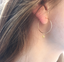 Close-up of a citrine hoop earring in gold filled