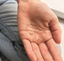 Delicate citrine hoop earrings held in hand to show size