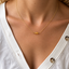 Dainty three-bead citrine necklace worn at the collarbone