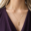 Opal vertical bar necklace in gold filled worn with a plum V-neck sweater