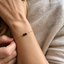 Delicate gold bracelet with black onyx beads on the wrist