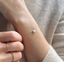 Gold filled opal teardrop bracelet worn on the wrist