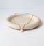 Delicate gold filled necklace with a pink opal teardrop on a stone dish