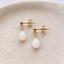 Gold filled opal drop stud earrings showing wire-wrapped opal teardrops