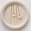 Pair of gold filled freshwater pearl threader earrings held up by hand, showing the cable chain length and wire-wrapped pearls