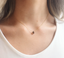 Dainty smoky quartz teardrop necklace worn at the collarbone