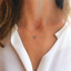 Labradorite necklace worn with an open white collared shirt