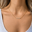 October birthstone opal bar necklace worn with blonde hair