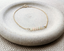 Gold filled opal bar bracelet with spring ring clasp on a stone dish