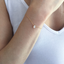 Minimalist opal teardrop bracelet in soft daylight