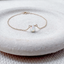 Gold filled opal teardrop bracelet on a stone dish
