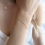 Opal teardrop bracelet layered with a matching opal teardrop necklace