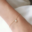 Delicate opal teardrop bracelet on a gold filled chain