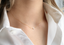 Dainty freshwater pearl necklace worn with a white button-up collar