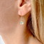 Model wearing a dainty prehnite drop earring in 14k gold-filled