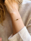 Dainty tiger's eye bracelet in 14k gold-filled worn on the wrist