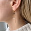 Gold black onyx and pearl threader earring on the ear - Lolabean