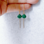 Hand holding a pair of gold filled emerald threader earrings showing the chain, emerald drop and threader bar
