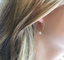 Ethiopian opal hoop earring showing its colorful fire