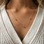 Garnet 3 bead station necklace worn with a V-neck sweater, showing the three garnet beads